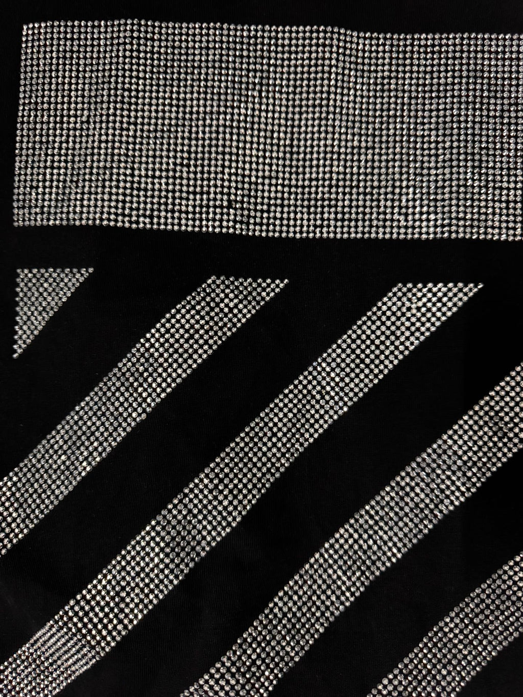Black T-shirt close-up of rhinestone diagonal stripe graphic
