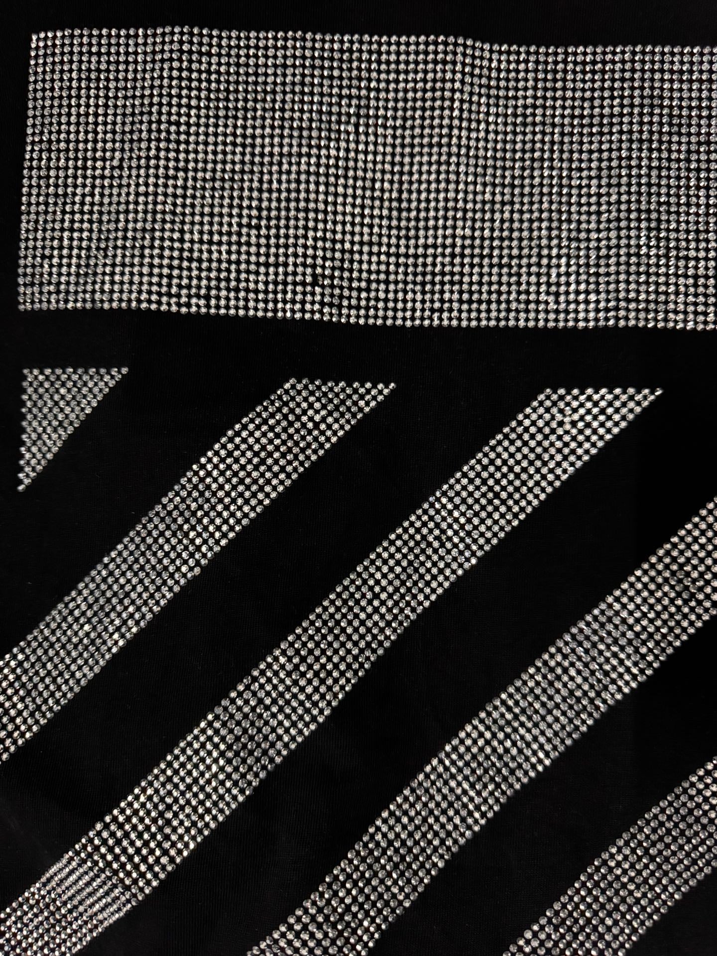 Black T-shirt close-up of rhinestone diagonal stripe graphic