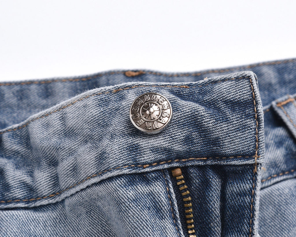 Light-wash denim shorts with circular logo button and waistband details