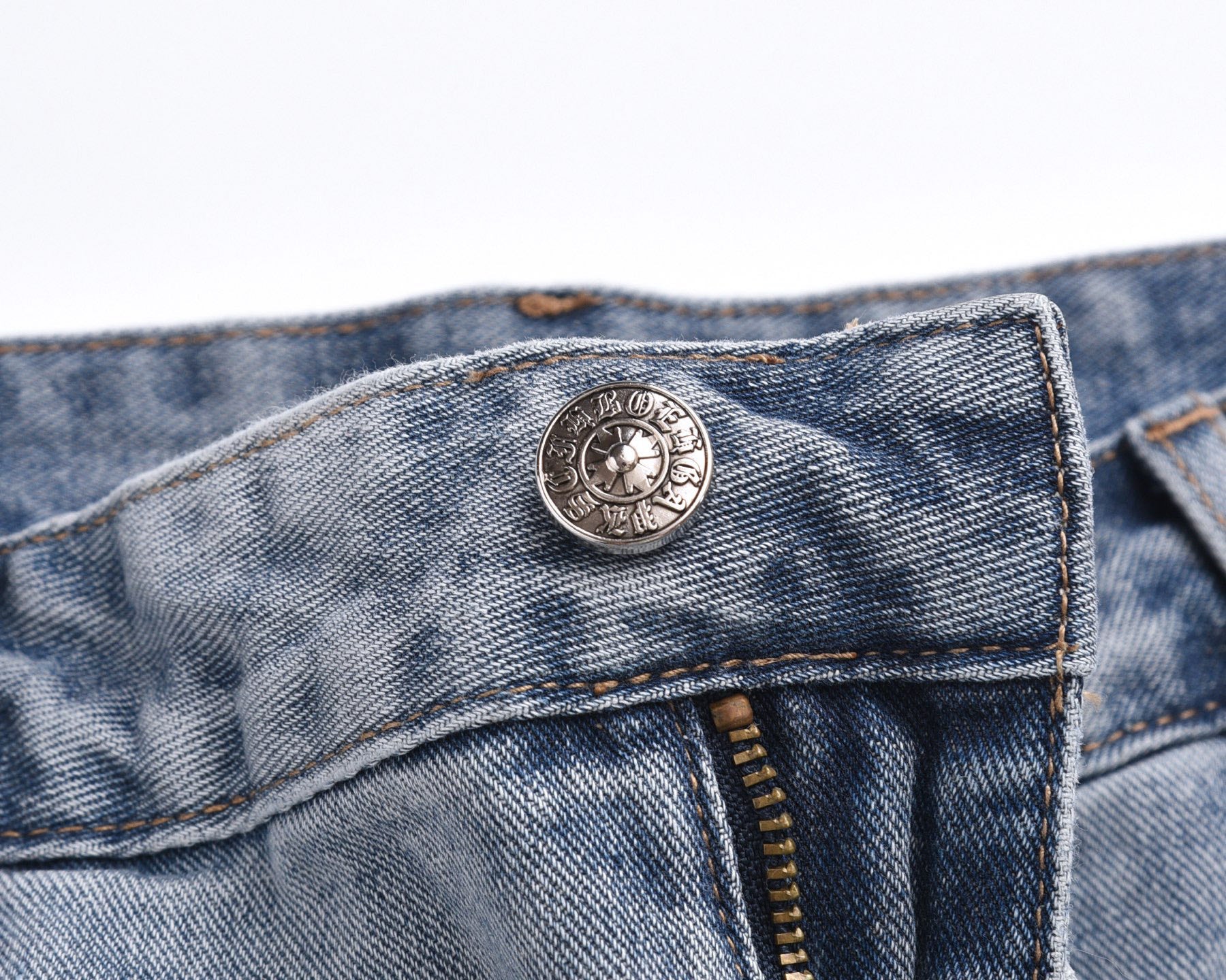 Light-wash denim shorts with circular logo button and waistband details