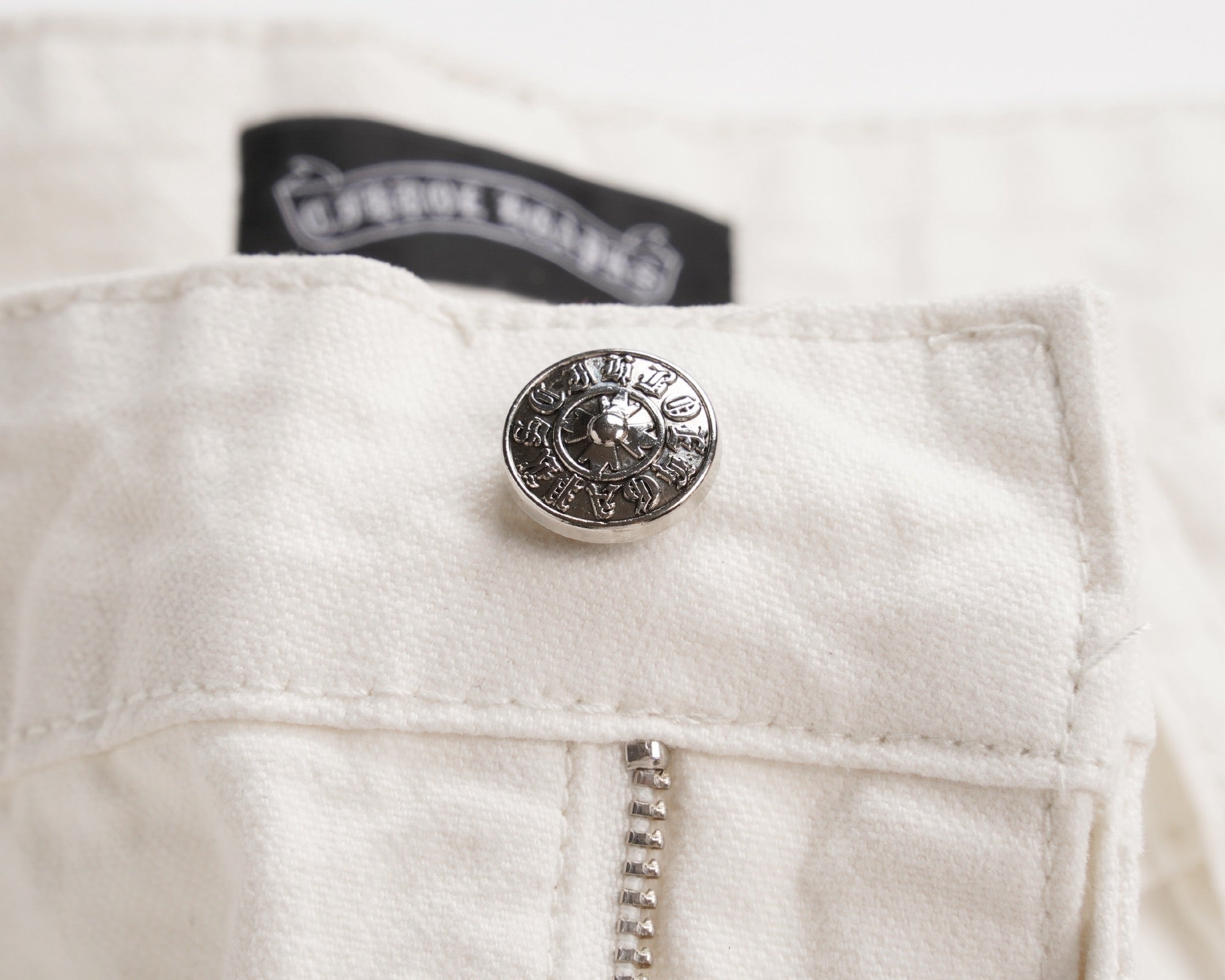 White shorts with metal button and embroidered waistband logo patch