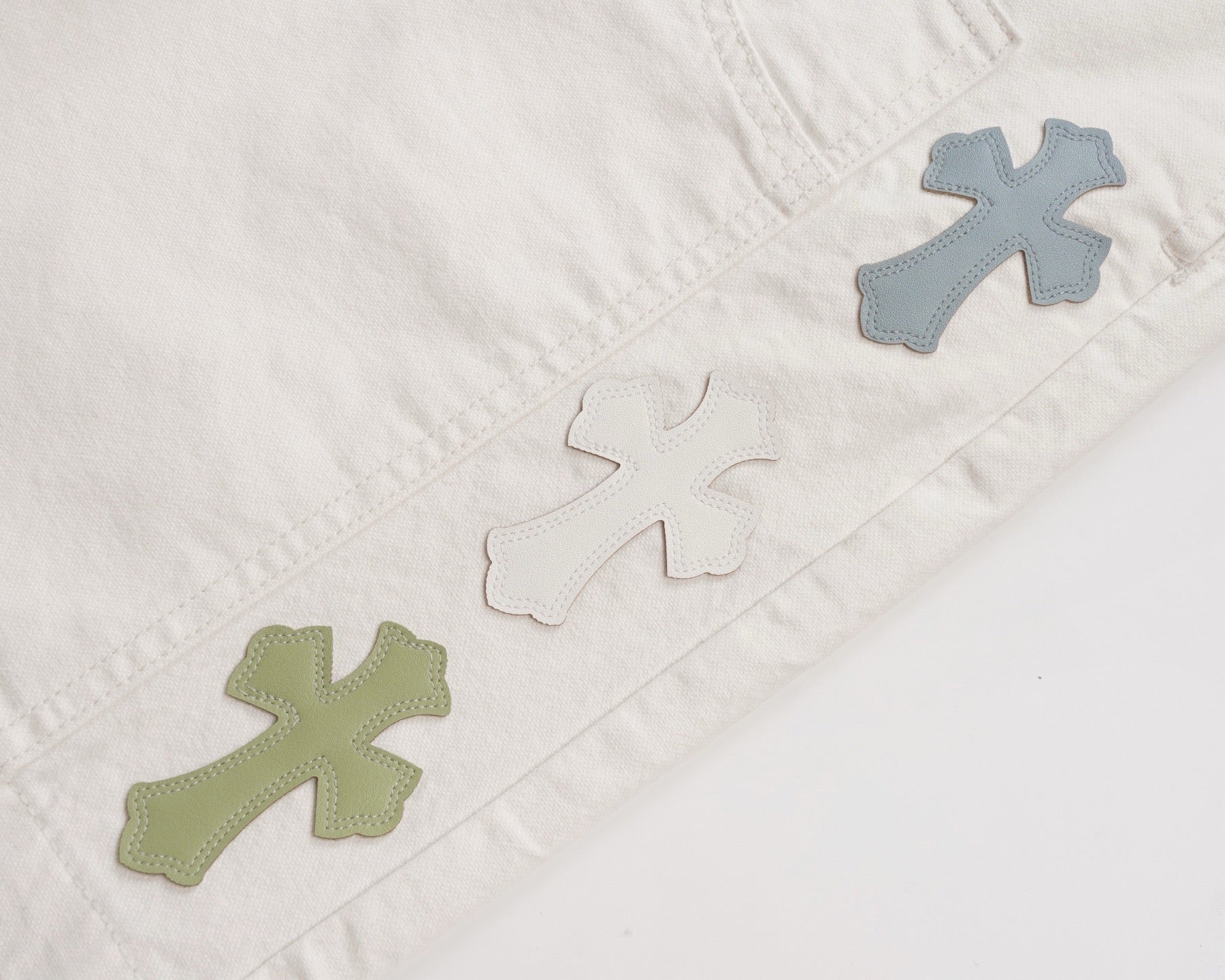 White shorts with green and blue cross patches on the front leg