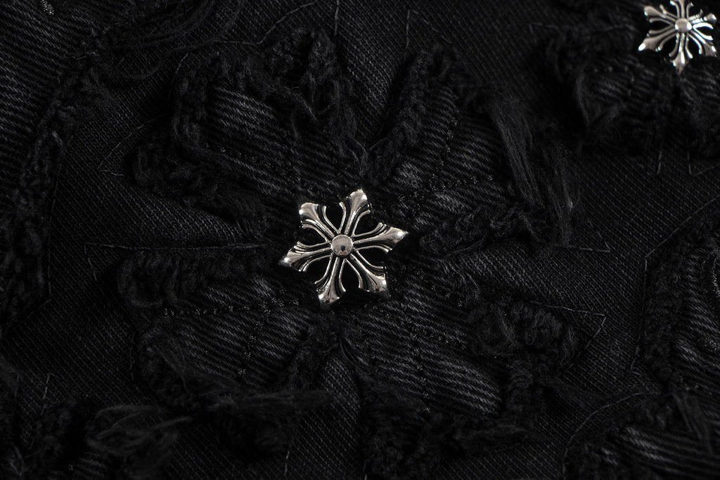 Embroidered black fabric patch with silver starburst detail