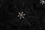 Embroidered black fabric patch with silver starburst detail