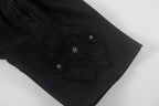 Black shorts with ornate embroidered center side patch
