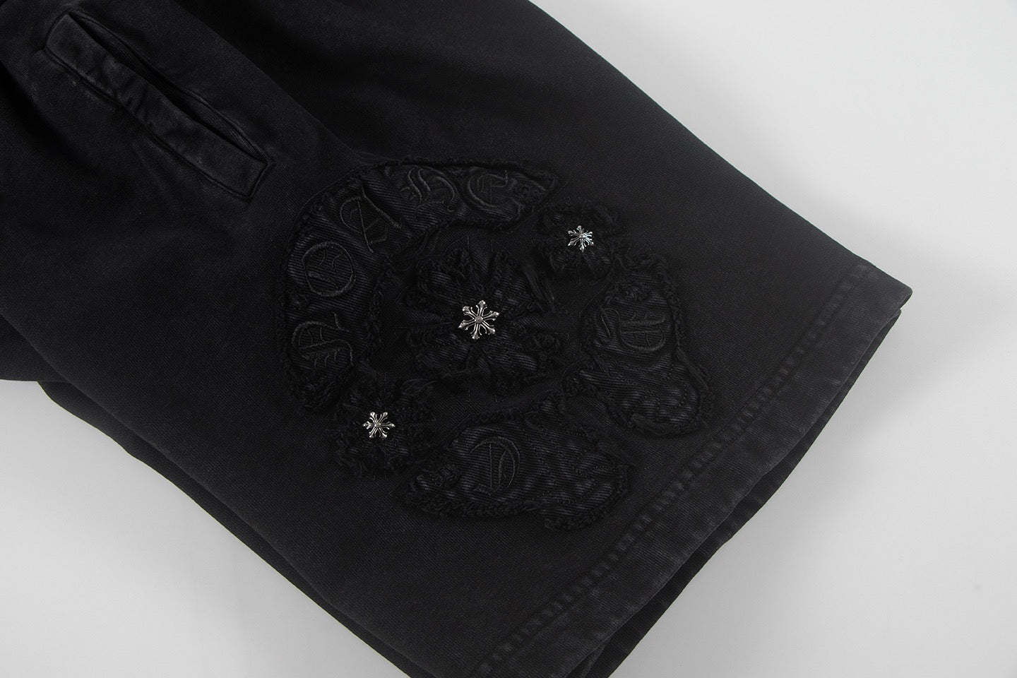 Black shorts with ornate embroidered center side patch