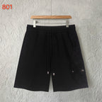 Black shorts with elastic waistband and embroidered side patches