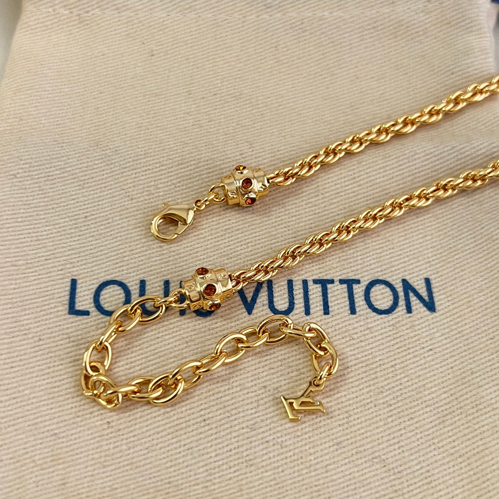 Gold-tone chain bracelet with studded clasp and charm links