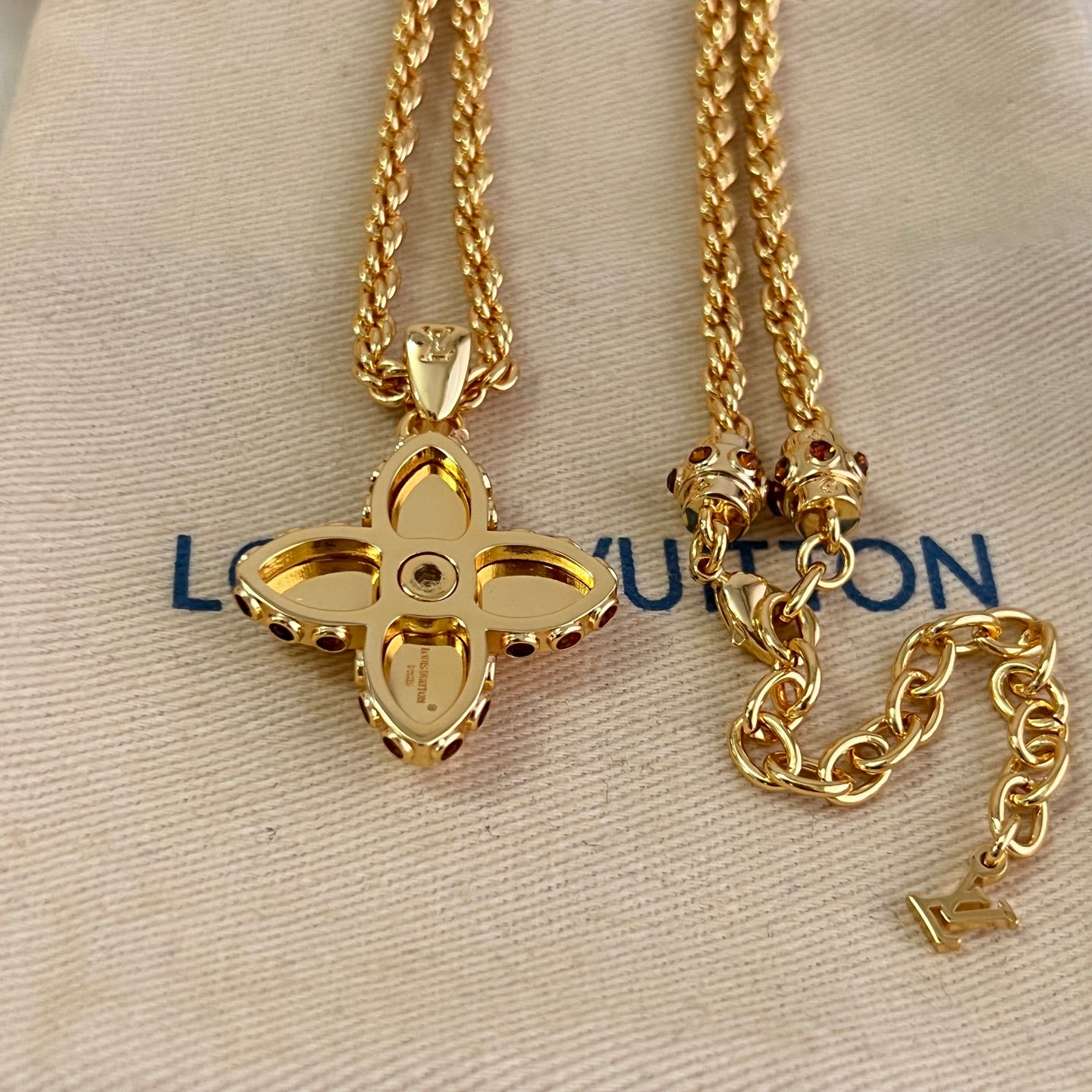 Gold-tone chain necklaces with quatrefoil monogram pendants