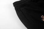 Black shorts with side pocket seam and pleated front detail