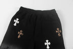 Black shorts with elastic waistband, side pocket, and cross appliques