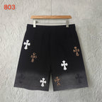 Black shorts with elastic waistband and scattered cross appliques, front view