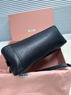 Black leather MiuMiu mini bag with structured shape, zipper top and shoulder strap
