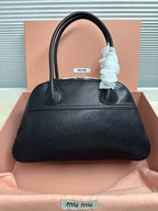 Black leather MiuMiu handbag with top handles and front logo patch