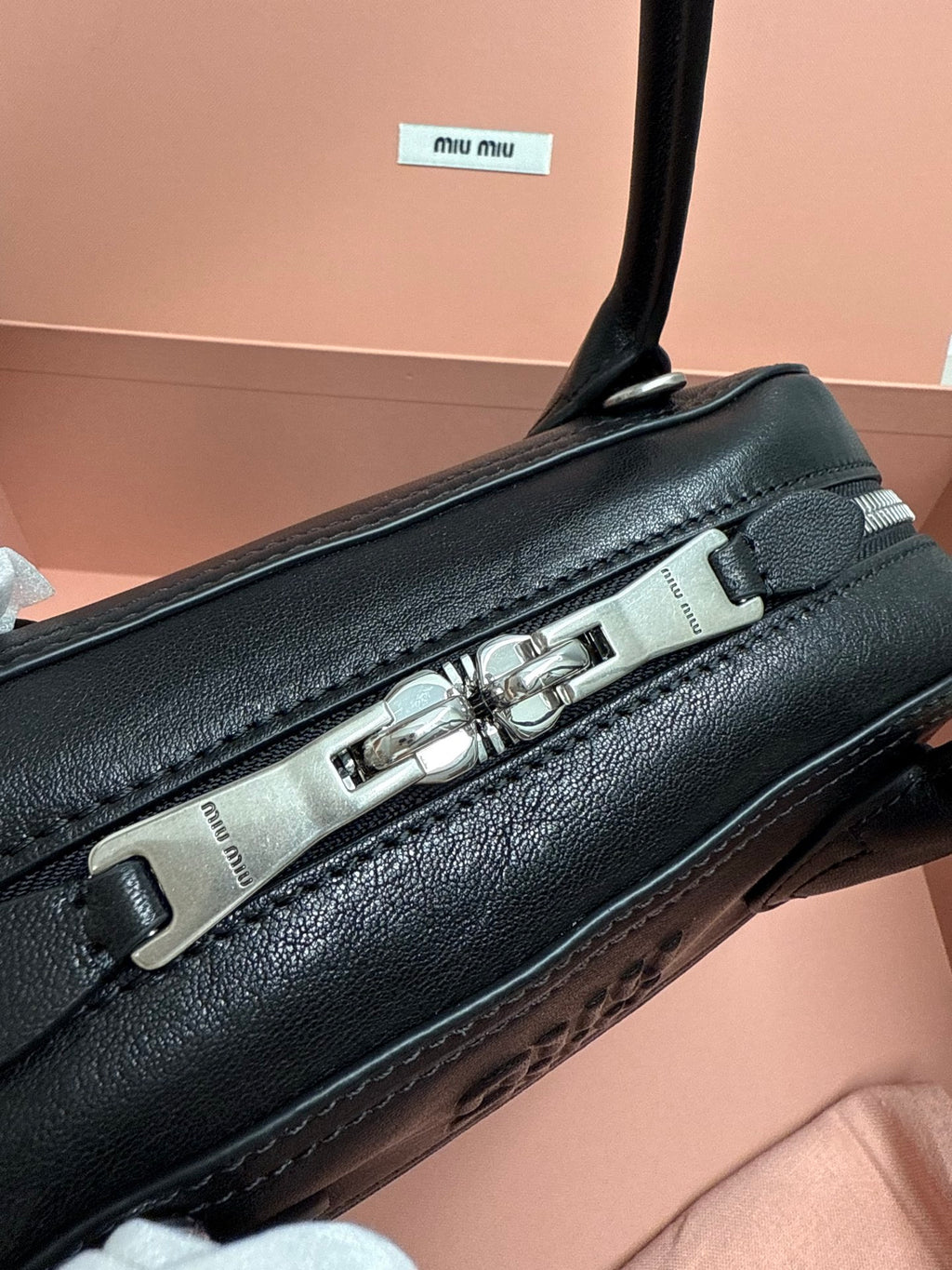 Black leather MiuMiu bag with silver-tone top clasp bar hardware
