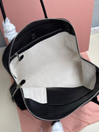 MiuMiu leather handbag interior open view with zip closure and pocket