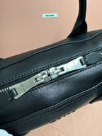 MiuMiu leather handbag close-up of metal zipper and top trim stitching