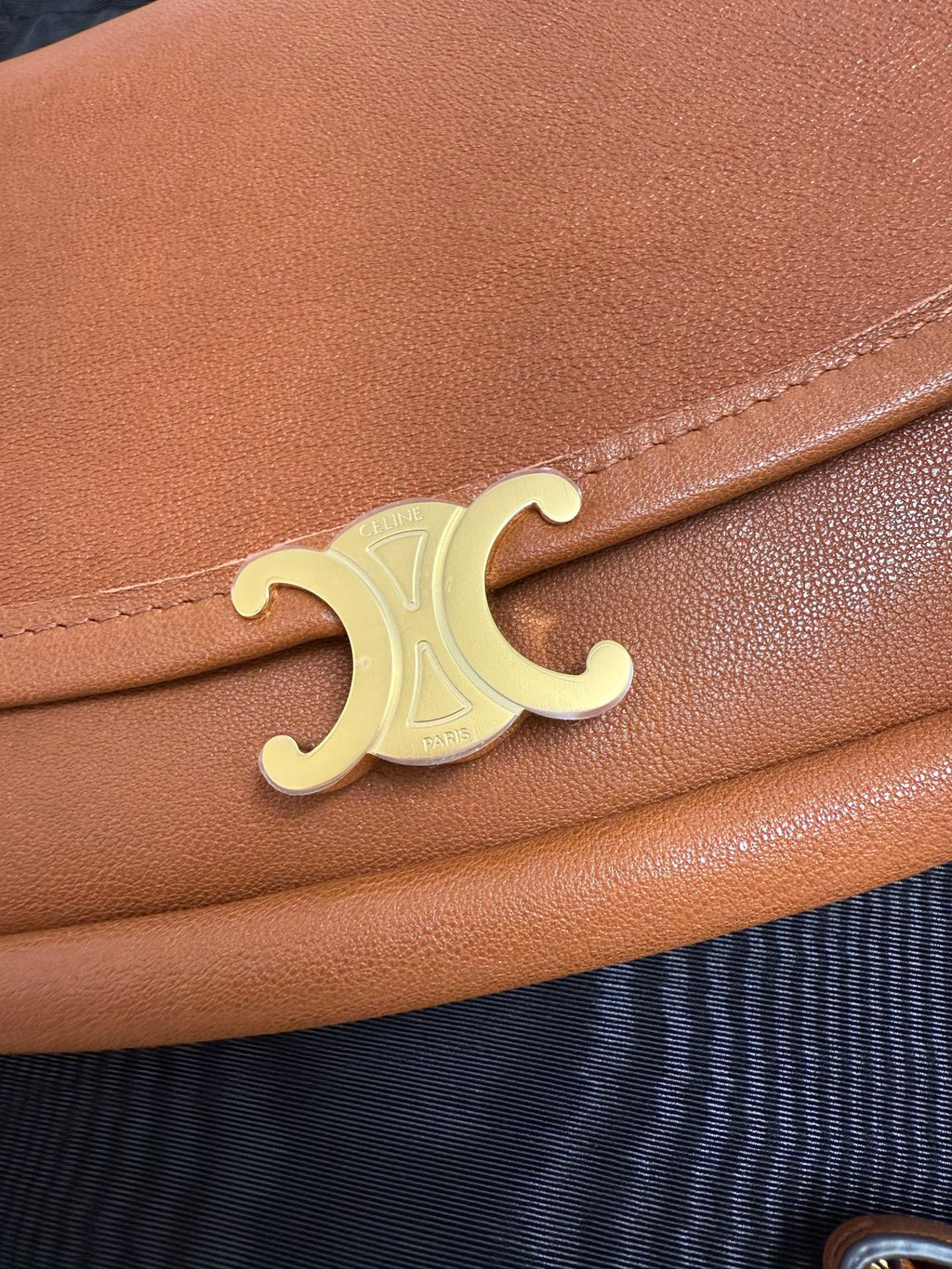 Celine gold C logo on brown leather flap
