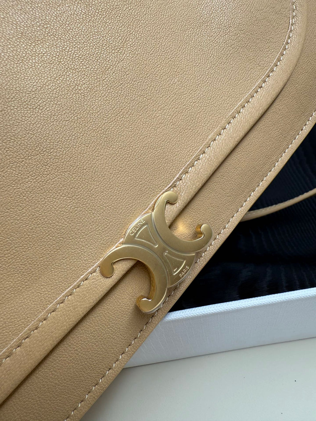 Celine beige leather crossbody bag close-up of gold front clasp and stitched trim