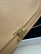 Celine beige leather crossbody bag close-up of gold front clasp and stitched trim