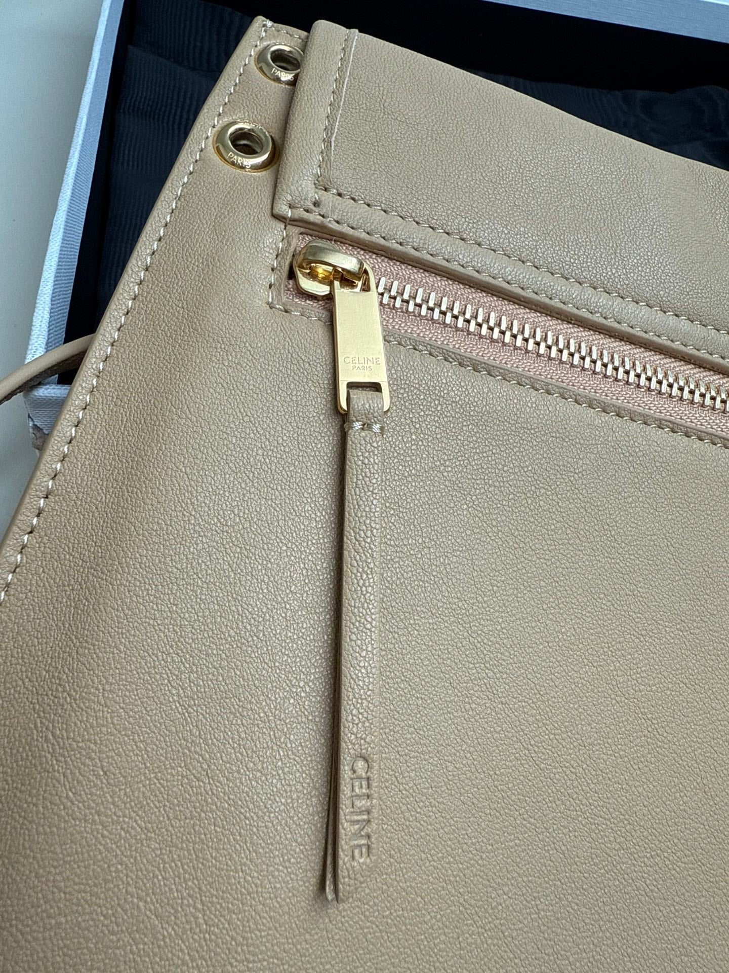 Celine beige leather crossbody bag close-up of interior zipper pull and gold hardware