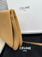 Celine beige leather crossbody bag side view with metal eyelets and strap