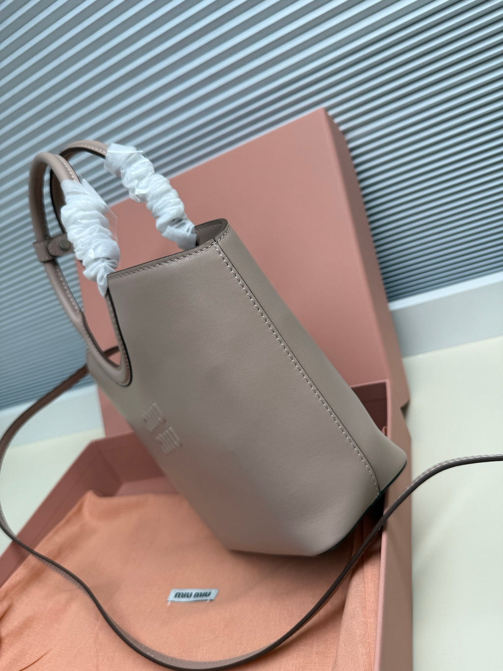 MiuMiu mini shoulder bag in light gray with short handle and long strap