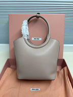 MiuMiu mini tote bag, light gray leather, rounded handles with blue scrunchie
