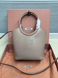 MiuMiu mini tote bag in light gray with top handles and embossed logo