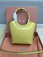 Lime green MiuMiu tote bag with top handle and embossed front logo