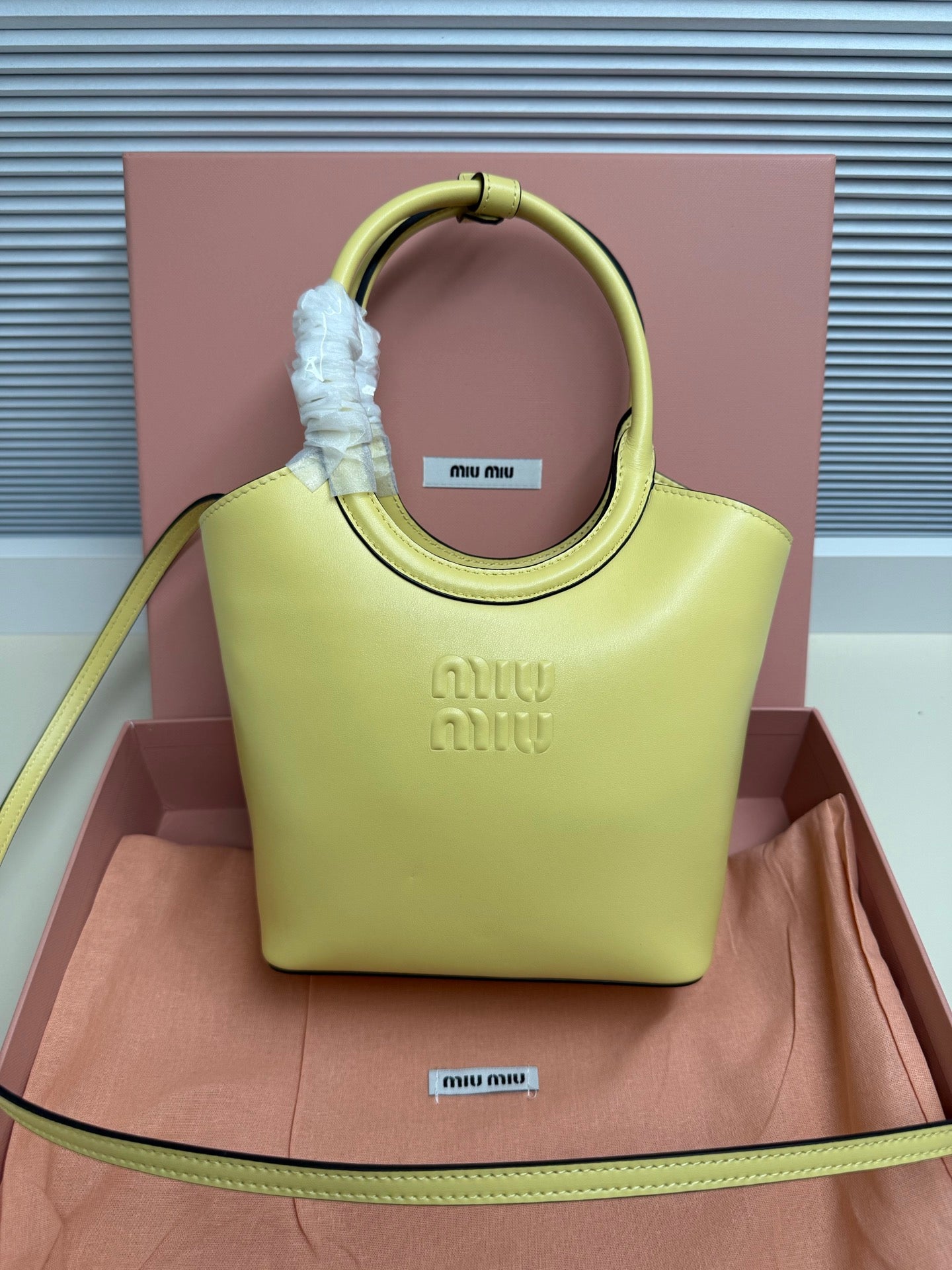 Lime green MiuMiu tote bag with top handle and embossed front logo