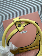 Lime green MiuMiu tote bag close-up of handle strap and hardware detail