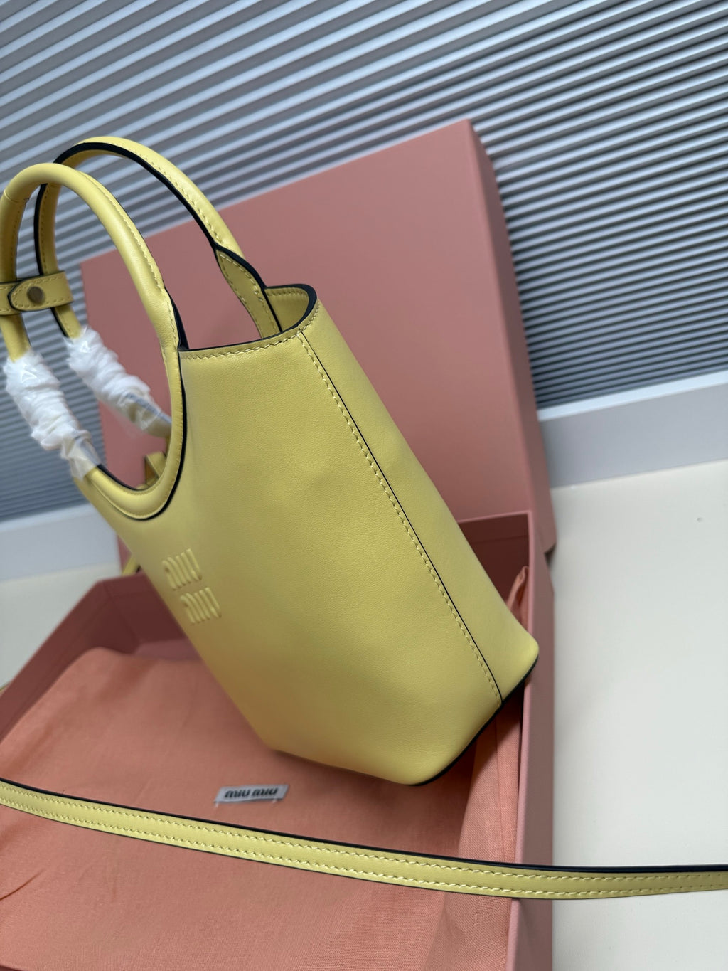 Lime green MiuMiu tote bag side view with top handle and contrast piping