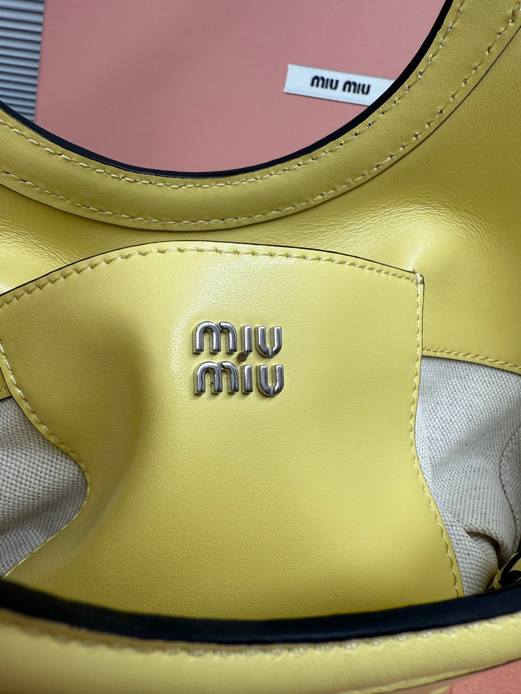 Lime green MiuMiu tote bag logo patch detail with stitched trim