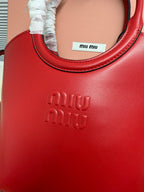 Red leather Miu Miu bag front with embossed “miu miu” logo and stitched trim