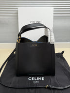 Celine structured handbag in dark leather with top handle, open front, gold-tone hardware