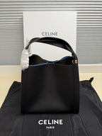 Celine handbag with top handle and blue interior, dark leather, gold-tone hardware detail