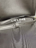 Celine dark leather handbag with striped canvas lining, front edge stitching and strap