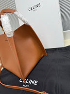 Celine tan leather mini handbag shown from the side with reinforced handle strap