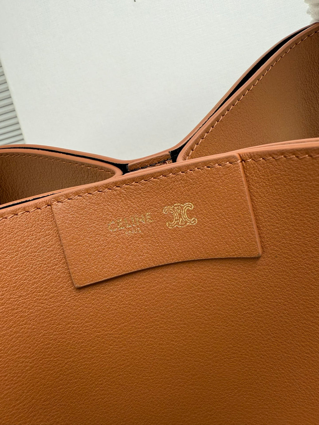 Celine tan leather handbag front panel with embossed logo and stitched tab