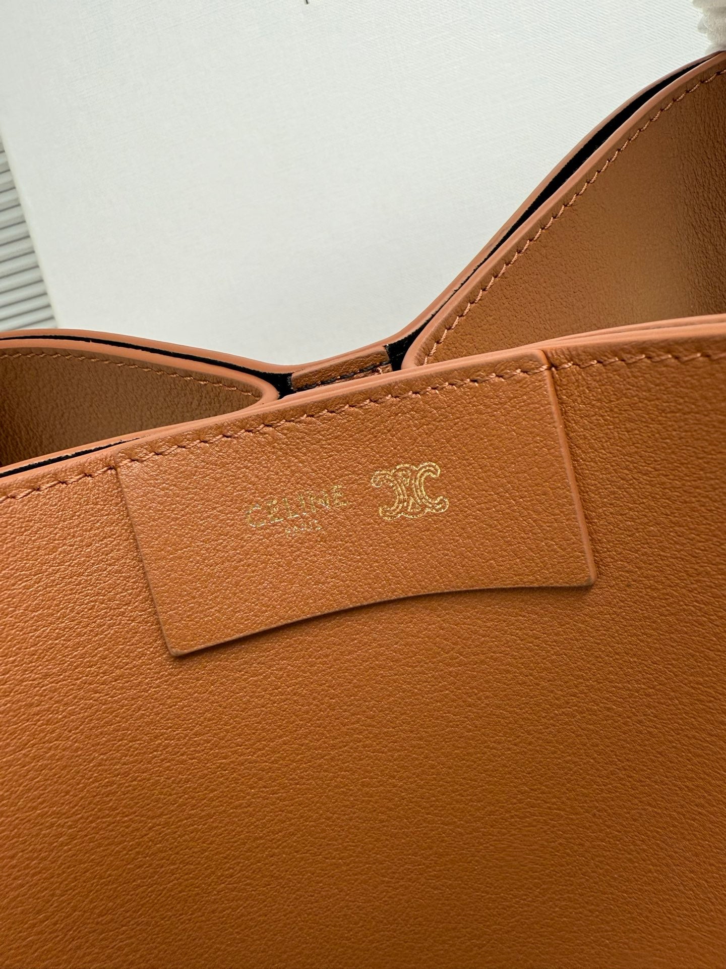 Celine tan leather handbag front panel with embossed logo and stitched tab