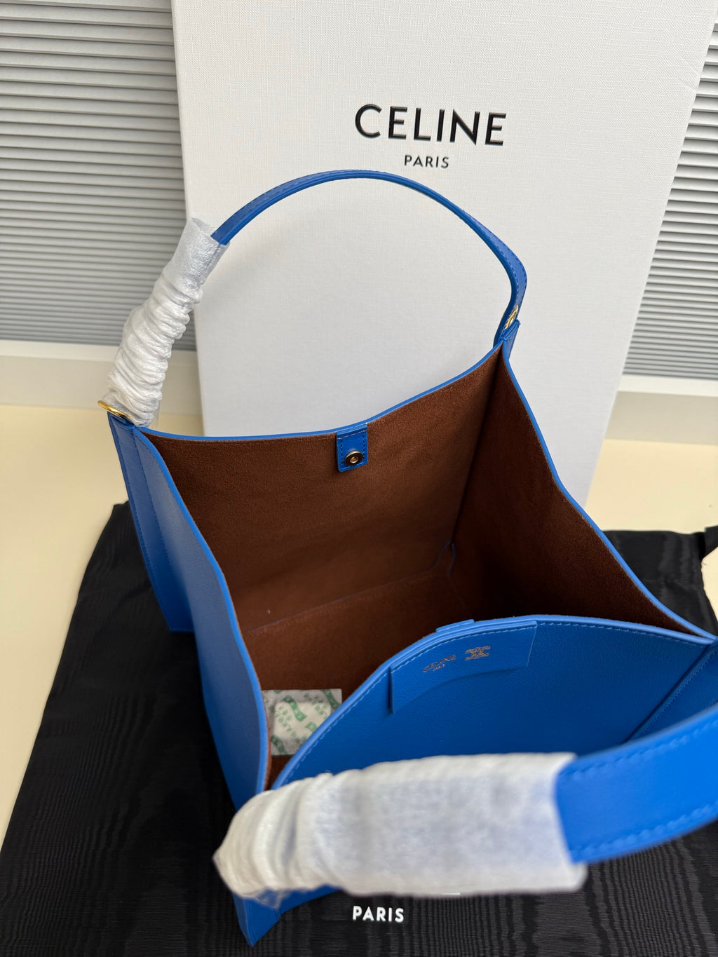 Celine blue leather tote bag showing brown interior lining