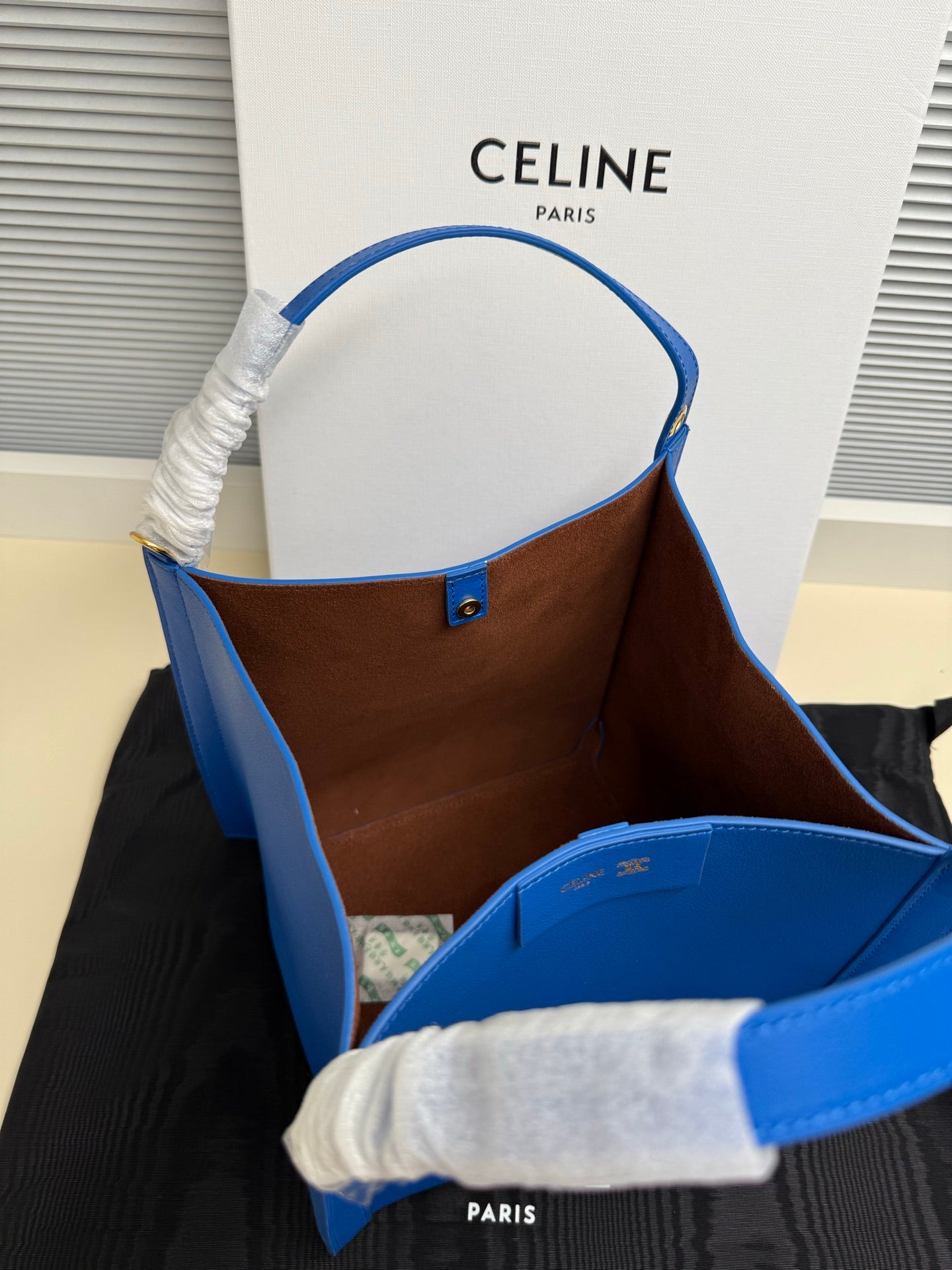 Celine blue leather tote bag showing brown interior lining
