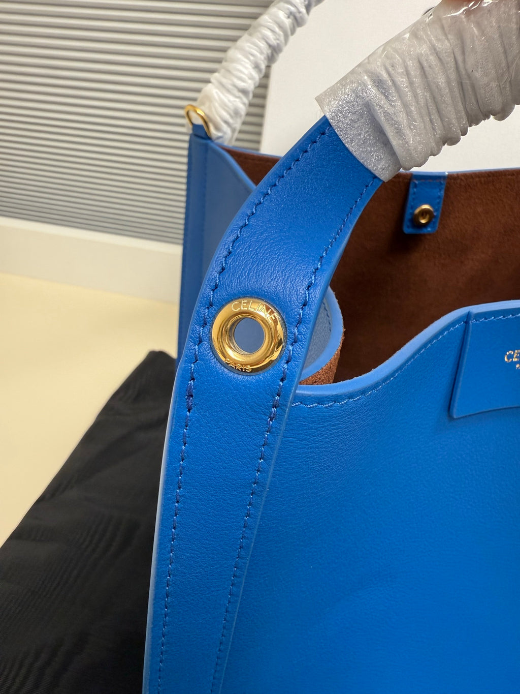 Celine blue leather bag with gold-tone ring detail at the side handle