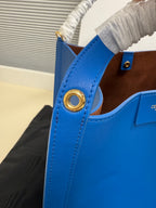 Celine blue leather bag with gold-tone ring detail at the side handle
