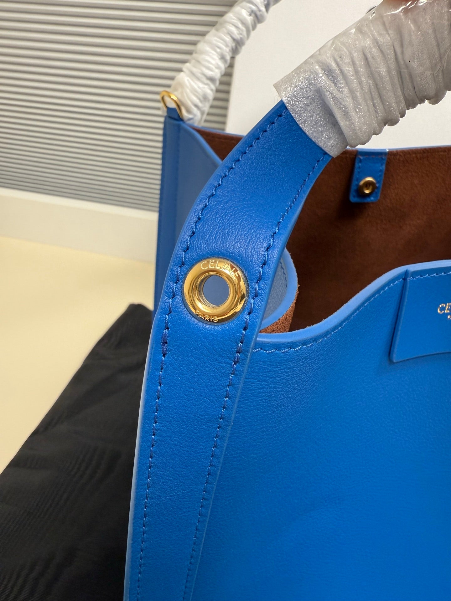 Celine blue leather bag with gold-tone ring detail at the side handle