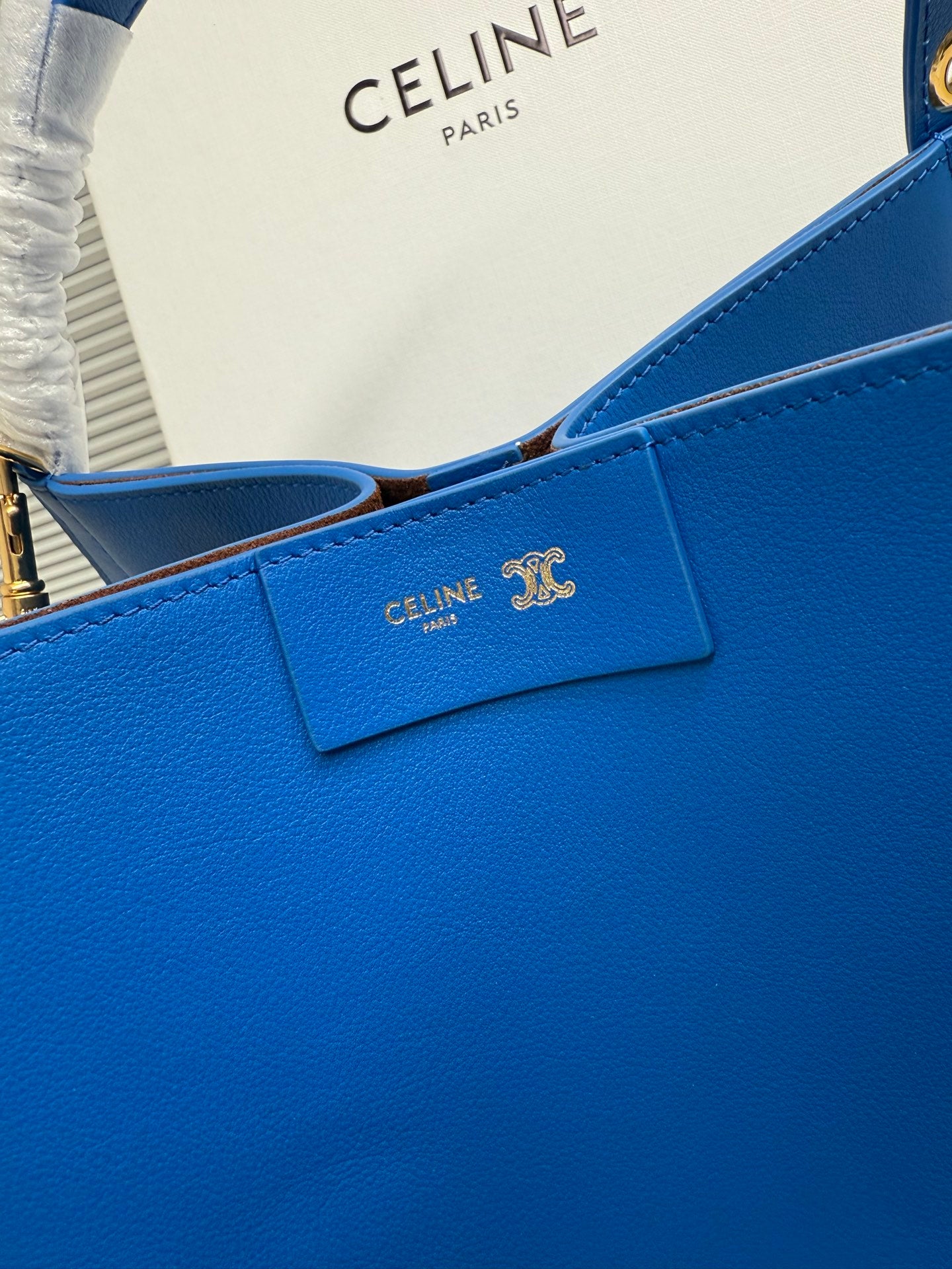 Celine blue leather bag front with small logo plaque and stitched flap