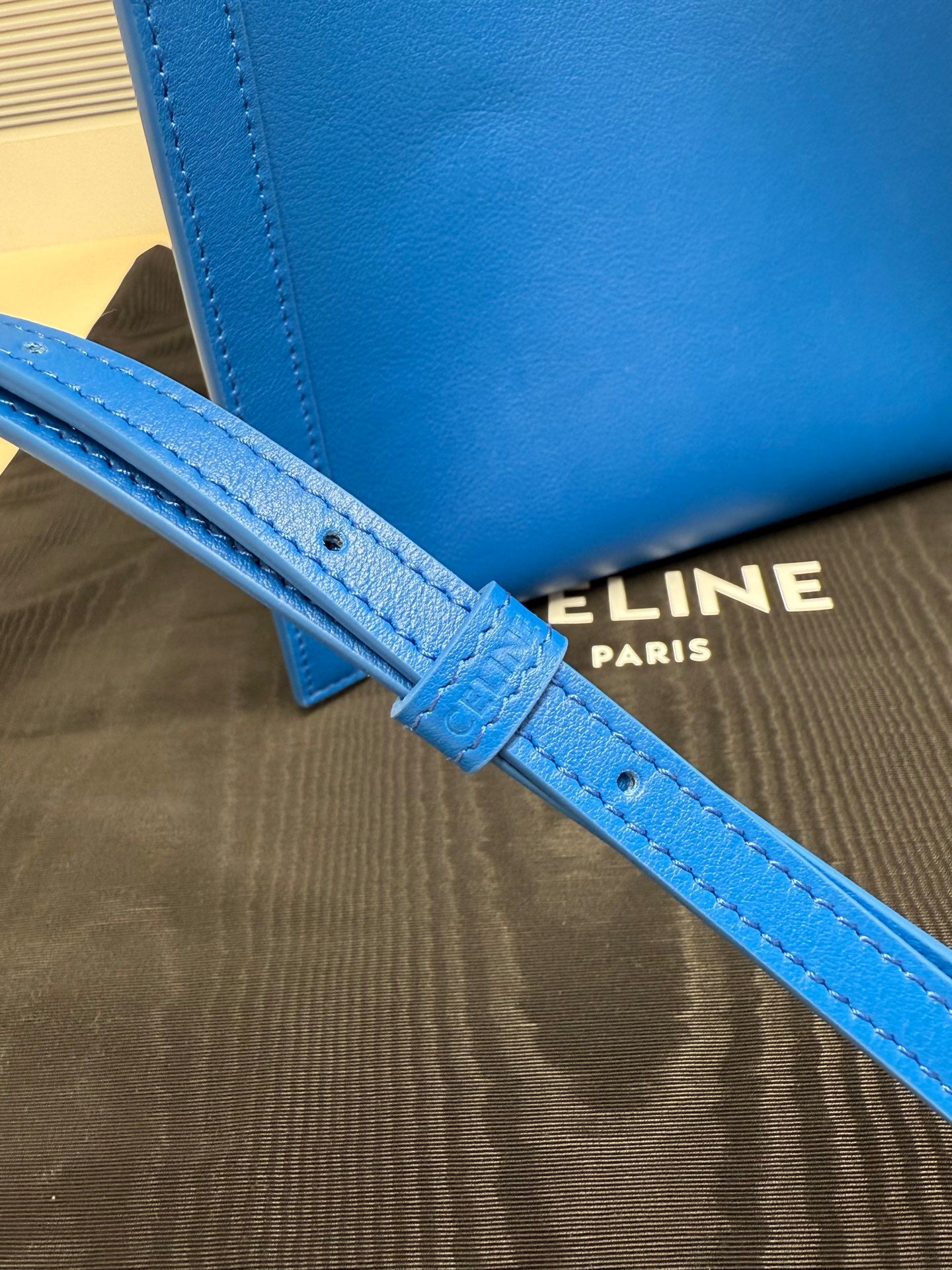 Celine blue leather shoulder strap with stitching and logo text on lining