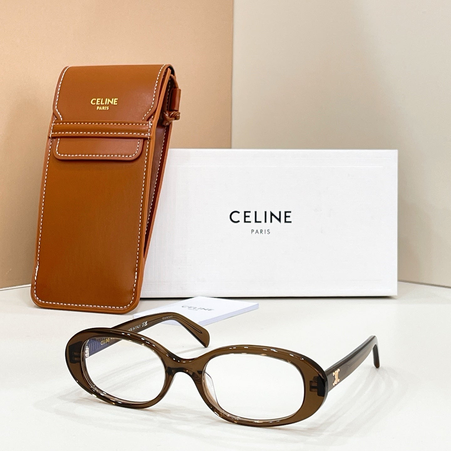 Celine eyeglasses with brown tortoiseshell frames and clear lenses, next to a leather case