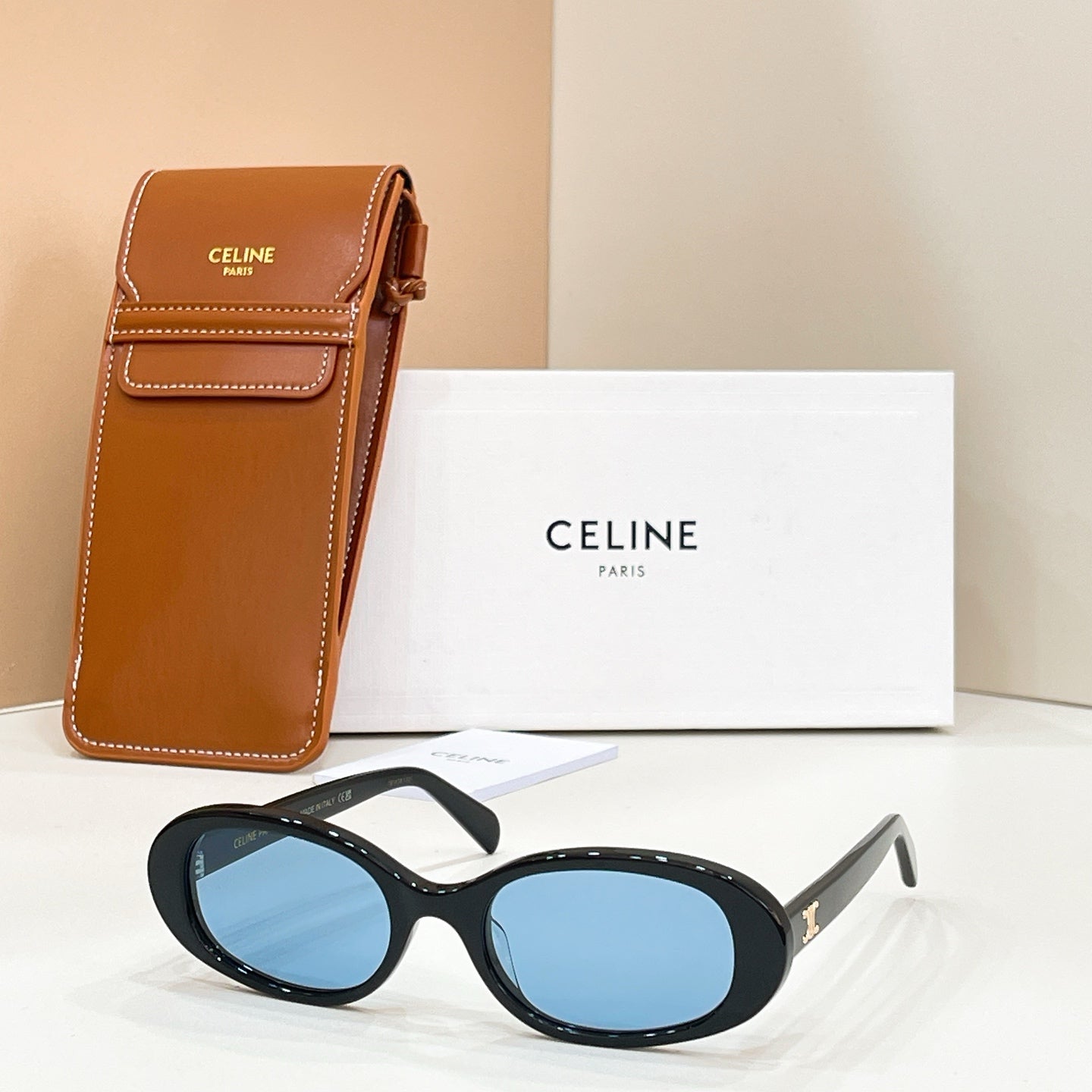 Celine sunglasses with black frames and blue tinted lenses, with brown leather case